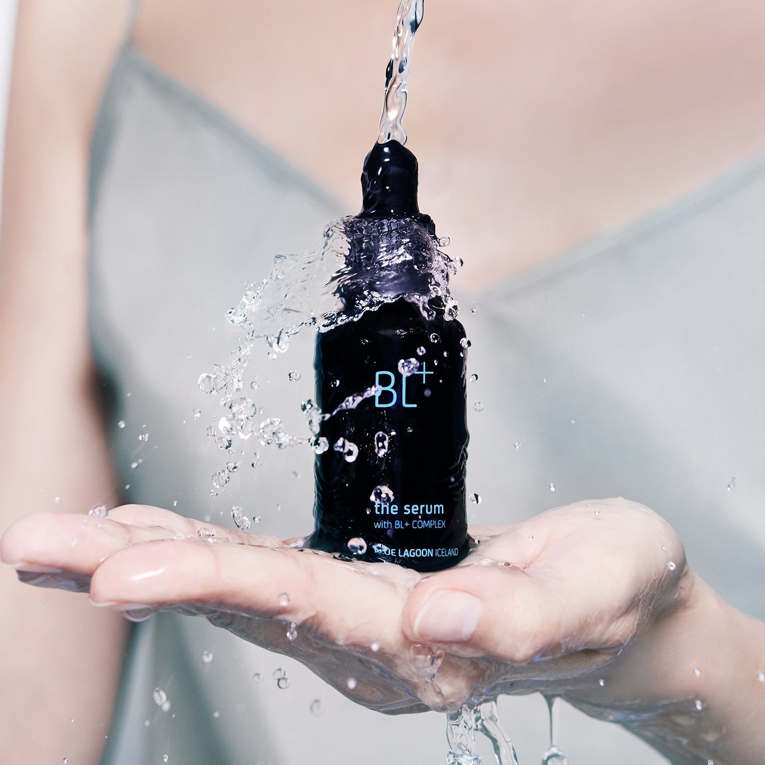 BL+ The Serum bottle surrounded by water, representing hydration and freshness