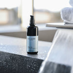Body Oil bottle on stone surface