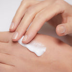 Model applying Mineral Moisturizing Cream on hand