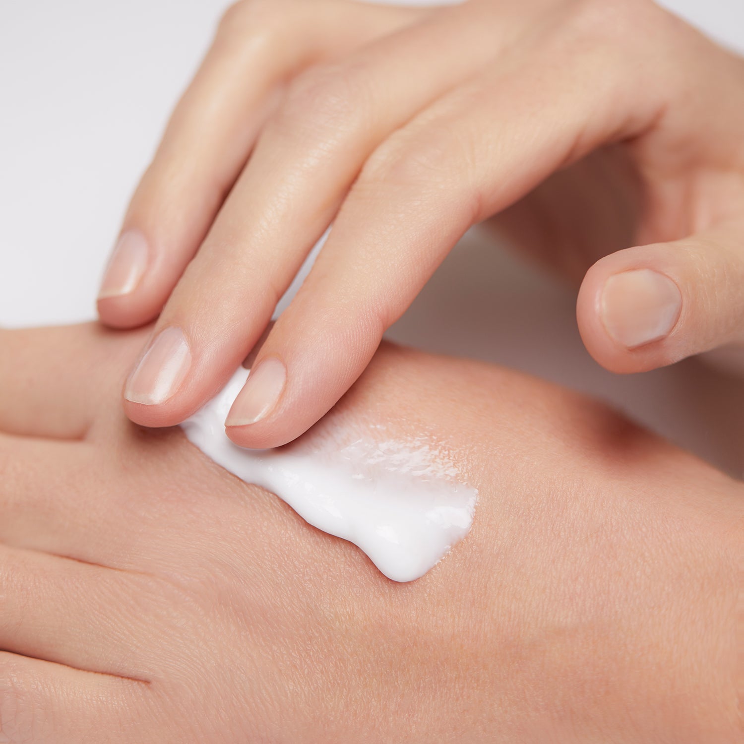 Model applying Mineral Moisturizing Cream on hand