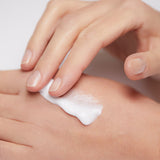 Model applying Mineral Moisturizing Cream on hand